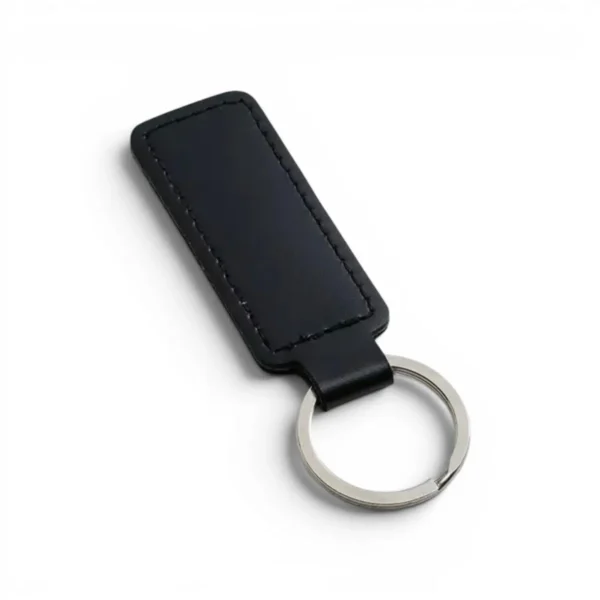 wikxy-laser-engraved-leather-keyholder-rectangular-shape-black A black, blank premium leather keyholder before customisation, showcasing the raw stitching and thick leather grain on a wooden workshop table by WIKXY.