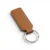 wikxy-laser-engraved-leather-keyholder-rectangular-shape-coffee-brown A coffe brown, blank premium leather keyholder before customisation, showcasing the raw stitching and thick leather grain on a wooden workshop table by WIKXY.