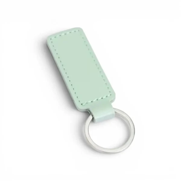 wikxy-laser-engraved-leather-keyholder-rectangular-shape-mint-green A mint green, blank premium leather keyholder before customisation, showcasing the raw stitching and thick leather grain on a wooden workshop table by WIKXY.